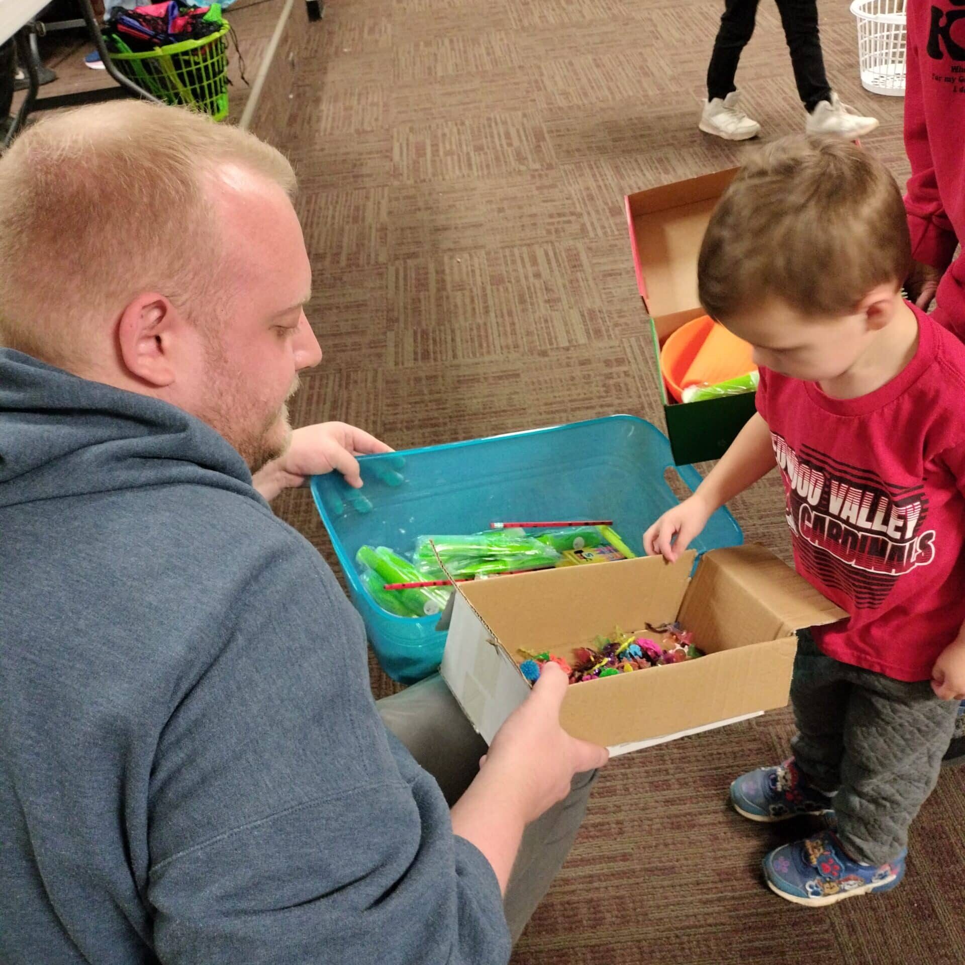 Adult and Child look at box